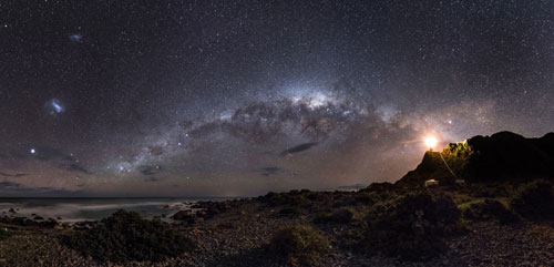 EARTH AND SPACE. Winner and Overall Winner: Mark Gee (Australia), Guiding Light to the Stars. The skies of the Southern Hemisphere offer a rich variety of astronomical highlights. The central regions of the Milky Way Galaxy, 26,000 light years away, appear as a tangle of dust and stars in the central part of the image. Two even more distant objects are visible as smudges of light in the upper left of the picture. These are the Magellanic Clouds, two small satellite galaxies in orbit around the Milky Way. © Mark Gee.