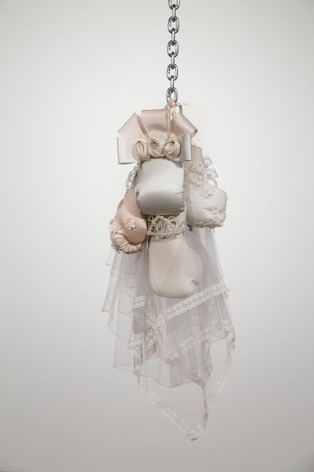 Zoe Buckman. Ode On, 2016. Chain, boxing gloves and embroidery on vintage wedding dresses, 41 x 16 x 17 in. Courtesy the artist and 21c Museum.