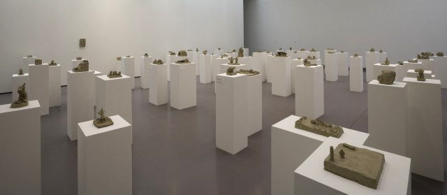 Peter Fischli David Weiss.  Selections from Suddenly This Overview, 1981. Series of approx 600 sculptures in unfired clay, various dimensions, between 6 x 7 x 5 cm and  82 x 83 x 5 cm © Peter Fischli and David Weiss.  Installation view: Peter Fischli & David Weiss: Flowers & Questions: A Retrospective, Kunsthaus Zürich, June 8–Sept. 9, 2007 Photograph: Courtesy Fischli Weiss Archive, Zürich.