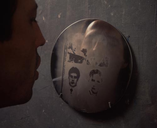 Oscar Muñoz. <em>Oscar Muñoz with Aliento (Breath)</em>, 1996-2002. Grease photo-silkscreen on steel discs, 20 cm each. Photograph © Thierry Bal, 2008