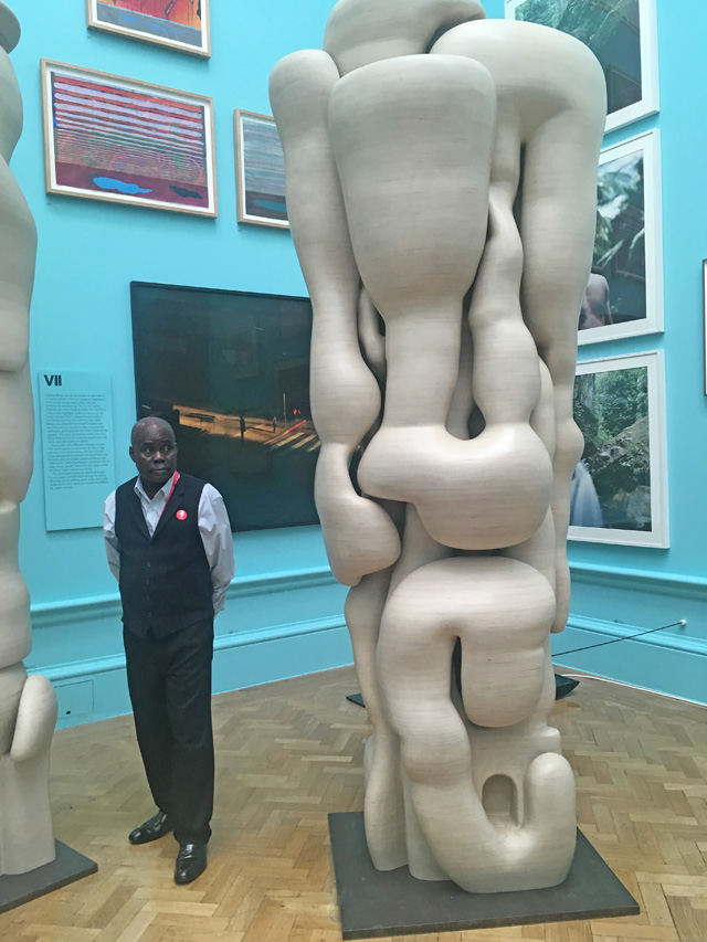 Tony Cragg. Lost in Thoughts. Wood, 240 x 80 x 130 cm. Installation view with member of RA staff. Photograph: Veronica Simpson.
