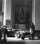 Cecil Beaton. Blitz: A workman with a wheelbarrow clears up fallen debris from the roof of St Mary-le-Bow after its first bombing, London, 1942. Part of Imperial War Museum’s ‘Ministry of Information Second World War Official Collection’.