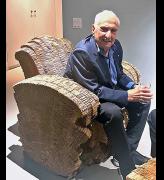 Frank Gehry sitting in one of the Little Beaver cardboard armchairs he designed. Photo: Ann Philbin.