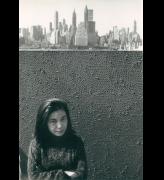 Yayoi Kusama with net painting and skyline in New York, c1961.