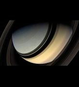 Dark side of the rings. This spectacular view looks down on Saturn’s northern regions, with its pole still in the darkness of the northern hemisphere winter. The rings cast a band of shadow across the gas giant world. Mosaic composite photograph. Cassini, 20 January 2007. NASA/JPL/Michael Benson, Kinetikon Pictures. Courtesy of Flowers Gallery.