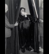 Helen Duncan emerging from curtains with ‘ectoplasm’ – her hands holding those of others
at the séance, Edinburgh, 1933. Photograph © Senate House Library, University of London.