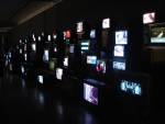 Douglas Gordon. <em>Pretty Much Every Film and Video Work From about 1992 Until Now to be Seen on Monitors, Some with Headphones, Others Run Silently, and all Simultaneously,</em> 1992–. Installation view.