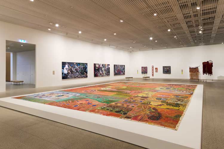 Foreground: Ngurrara Artists, Ngurrara Canvas II, 1997. Courtesy of the artists and the Ngurrara Canvas Management Group (NCMG) © Ngurrara Artists. Installation view, 25th Biennale of Sydney, Rememory, 2026, Art Gallery of New South Wales. Photo © Art Gallery of New South Wales, Felicity Jenkins.