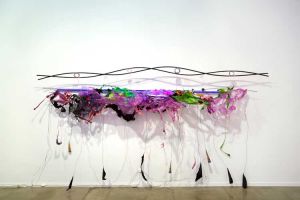 Judy Pfaff, Ram’s Delhi, 2012. Wood, mild steel rod, melted plastics, black aluminum foil, and LED and UV Fluorescent light, 70 x 132 x 17 in. Collection of the artist, New York.