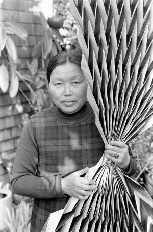 Laurence Cuneo, Ruth Asawa holding a paperfold, c1970s. Gelatin silver print, 9 13/16 × 7 5/16 in (24.9 × 18.6 cm). Courtesy of the Department of Special Collections, Stanford University Libraries. Photograph © Laurence Cuneo. Artwork © 2023 Ruth Asawa Lanier, Inc. / Artist Rights Society (ARS), New York. Courtesy David Zwirner.