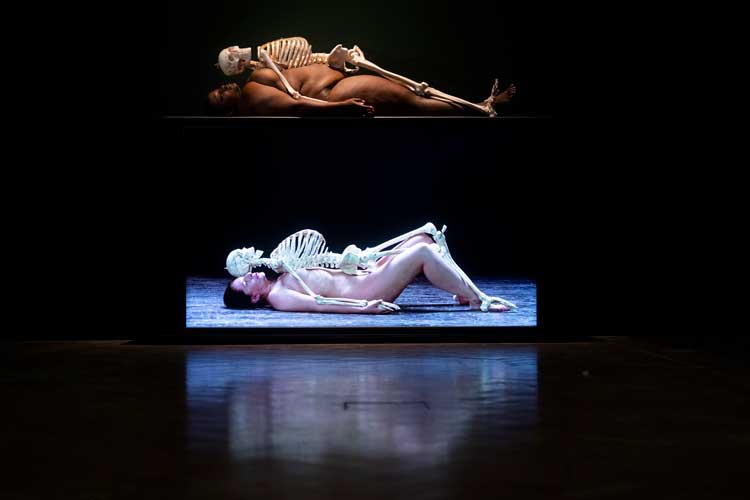 Nude with Skeleton, 2002/2005/2023. Live performance by Madinah Farhannah Thompson, 2 hours. Gallery view of the Marina Abramović exhibition at the Royal Academy of Arts, London, 23 September 2023 – 1 January 2024. Courtesy of the Marina Abramović Archives, and Galerie Krinzinger. © Marina Abramović. Photo © Royal Academy of Arts, London / David Parry.