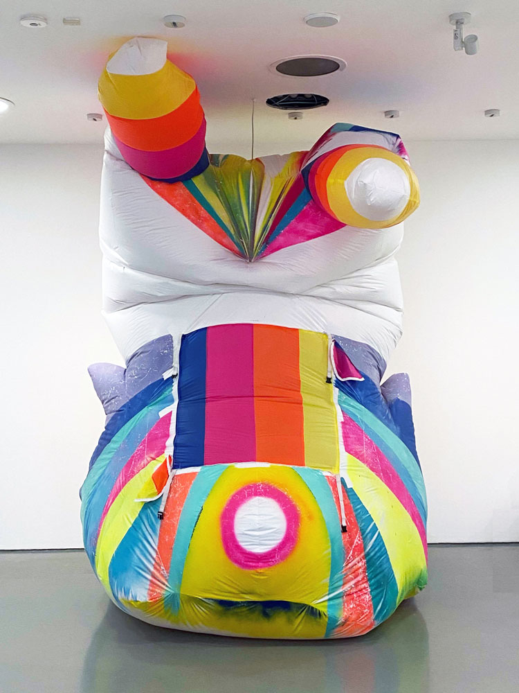 Claire Ashley. Clown (Laughing Stock), 2020. Spray paint on PVC coated Ripstop nylon, webbing straps, zippers, fan. Approximately 305 x 183 cm (10 x 6 ft). Commissioned by the Henry Moore Institute in Leeds for the Portable Sculpture exhibition.