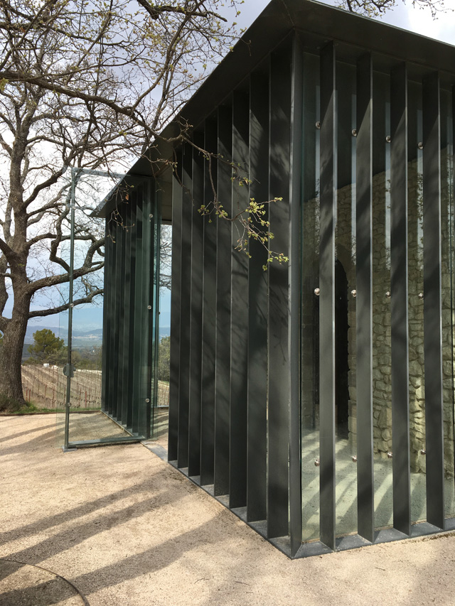 The stone hut inside glass pavilion La Chapelle at Château La Coste. Photo: Veronica Simpson.