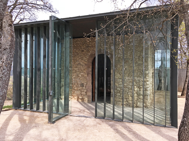 The stone hut inside glass pavilion La Chapelle at Château La Coste. Photo: Veronica Simpson.