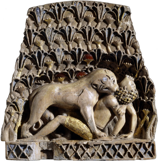 Ivory plaque of a lioness mauling a man. Ivory, gold, cornelian, lapis lazuli, Nimrud, 900BC – 700BC. © The Trustees of the British Museum.