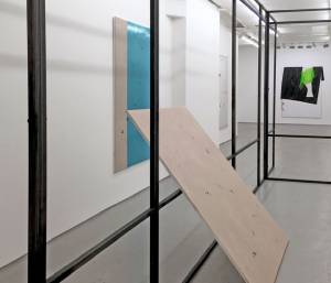 Weaving a path in and out of Peter Welz’s awkward steel architectural intervention, the viewer comes up close and personal, in an unsettling way, with Michaela Zimmer’s layered canvases. Scratch the surface and there is far more to be told than at first meets the eye