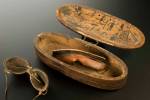 R for RESOURCEFULNESS. Inuit snow goggles and wooden case decorated with hunting scenes. Carved wood and rawhide, 19th century © Science Museum/Wellcome Collection. Goggles such as these were invented by the Inuit people of North America about 2,000 years ago to protect wearers against snow blindness.