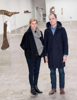 Allora & Calzadilla. Portrait of the artists. Background: Intervals, 2014. Re-configured acrylic
lecterns and dinosaur bones. Dimensions variable. Courtesy of the artists. In collaboration with
The Fabric Workshop and Museum, Philadelphia. Photograph: Constance Mensch.