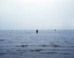 Antony Gormley. <em>Another Place</em>, 1997. Cast iron, 189 x 53 x 29 cm (100 elements). Installation view, Cuxhaven, Germany. © Antony Gormley. Photograph by Helmut Kunde.