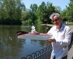 <p>Kit Poulson with boat made by Kit Poulson, Edwina Ashton and Mirabel Ashton-Poulson, 2012.