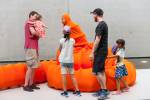 Anida Yoeu Ali. The Buddhist Bug, 2015. Orange lycra, wire, tube, thread, glue and two live bodies. Performance for The 8th Asia Pacific Triennial of Contemporary Art, Gallery of Modern Art, Brisbane, 21–22 November 2015. Courtesy: The artist.