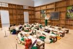 NGE Lay. The sick classroom, 2013. 27 wooden sculptures, timber walls, eight desks, 26 student accessories, one table, one chair; 15 photographs. Installation view, The 8th Asia Pacific Triennial of Contemporary Art, 2015. Collection: Queensland Art Gallery.