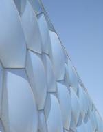 The façade of the Water Cube adopting a pastel blue hue.