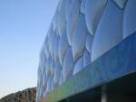 The soft, bulging ETFE pillows of the Water Cube in contrast with the hard metallic structures of the Bird Nest.