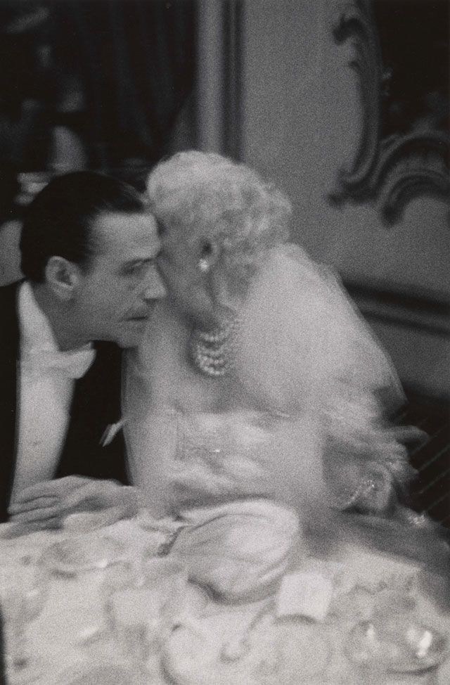 Diane Arbus. Elderly woman whispering to her dinner partner, Grand Opera Ball, N.Y.C. 1959. © The Estate of Diane Arbus, LLC. All Rights Reserved.