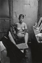 Diane Arbus. Stripper with bare breasts sitting in her dressing room, Atlantic City, N.J. 1961. © The Estate of Diane Arbus, LLC. All Rights Reserved.