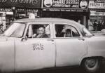 Diane Arbus. Taxicab driver at the wheel with two passengers, N.Y.C. 1956. © The Estate of Diane Arbus, LLC. All Rights Reserved.