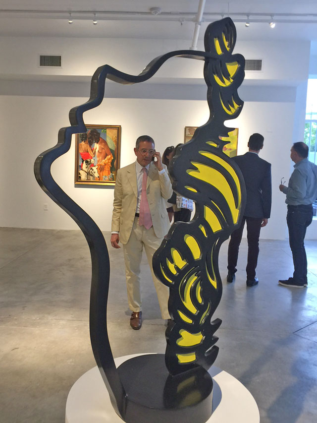 Jeffrey Deitch on cellphone as seen through the Lichtenstein. Photograph: Jill Spalding.