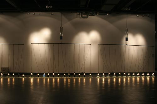 Suzann Victor. <em>Expense of Spirit in a Waste of Shame </em>2002. Light bulbs, mirrors, cables, mechanical rockers, control unit, broken glass.