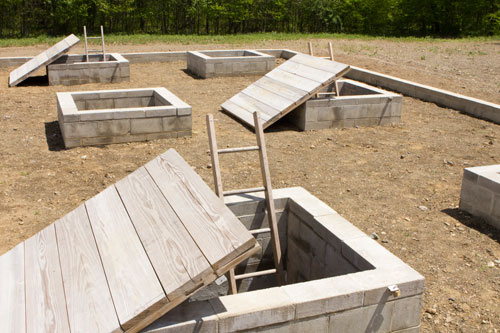 Alice Aycock. A Simple Network of Underground Wells and Tunnels, 1975/2012. View 2. Concrete, wood, earth, approximately 28’ x 50’ x 9’ deep. Originally sited at Merriewold West, Far Hills, New Jersey, (destroyed); Permanently reconstructed at The Fields Omi/Architecture Omi, Ghent, NY, 2011. Photograph: Dave Rittinger.