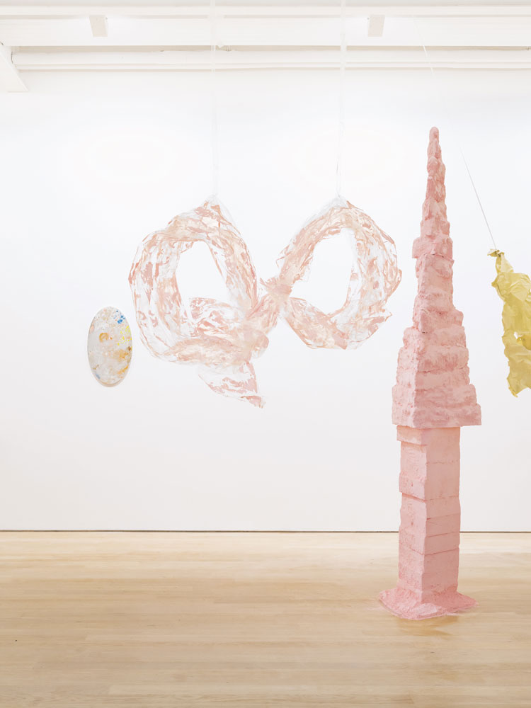 Karla Black. Left to right: Looking Glass number 16, 2021, mirror, glass paint, Courtesy Galerie Gisela Capitain, Cologne and Modern Art, London; Traps Take Practice, 2011, cellophane, paint, Sellotape, David and Indrė Roberts Collection; Don’t Depend, 2011, polystyrene, plaster, powder paint, plaster powder, paint, Collection of Nicoletta Fiorucci Russo De Li Galli, London; Opportunities For Girls, 2006/2021, sugar paper, chalk, ribbon, green concealer stick, nail varnish, Courtesy Galerie Gisela Capitain, Cologne and Modern Art, London.