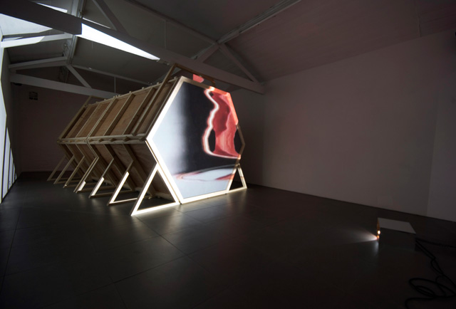 Laura Buckley. Fata Morgana, 2012. Sculpture: mixed media, mirrored acrylic, plywood, tinder, projection fabric; Film: digital video duration 8:18 min, 480 x 290 x 242 cm. © Laura Buckley, 2012. Image courtesy of Saatchi Gallery, London.