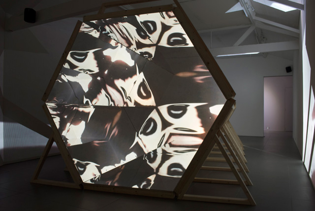 Laura Buckley. Fata Morgana, 2012. Sculpture: mixed media, mirrored acrylic, plywood, tinder, projection fabric; Film: digital video duration 8:18 min, 480 x 290 x 242 cm. © Laura Buckley, 2012. Image courtesy of Saatchi Gallery, London.