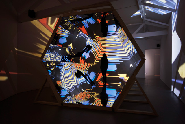 Laura Buckley. Fata Morgana, 2012. Sculpture: mixed media, mirrored acrylic, plywood, tinder, projection fabric; Film: digital video duration 8:18 min, 480 x 290 x 242 cm. © Laura Buckley, 2012. Image courtesy of Saatchi Gallery, London.