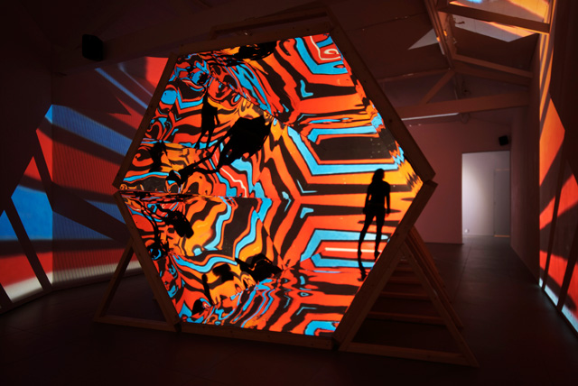 Laura Buckley. Fata Morgana, 2012. Sculpture: mixed media, mirrored acrylic, plywood, tinder, projection fabric; Film: digital video duration 8:18 min, 480 x 290 x 242 cm. © Laura Buckley, 2012. Image courtesy of Saatchi Gallery, London.