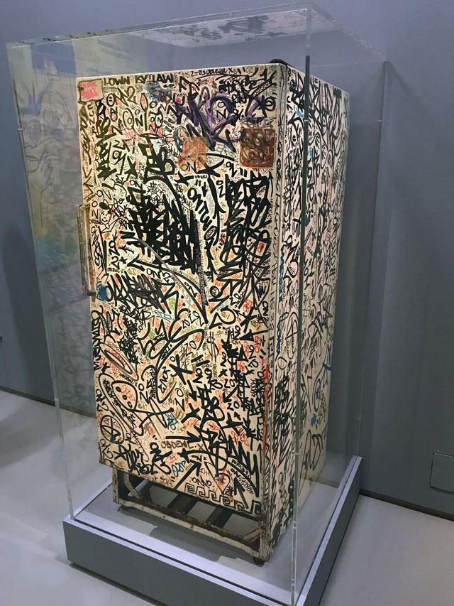Jean-Michel Basquiat with Fab 5 Freddy, Futura 2000, Keith Haring, Eric Haze, LA2, Tseng Kwong Chi, Kenny Scharf and others. Untitled (Fun Fridge), 1982. Installation view, Basquiat: Boom for Real, Barbican Art Gallery, London, 2017. Photograph: Martin Kennedy.