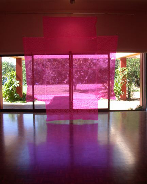 Irene Barberis. <em>Crosses Stars + Circles</em>, 2004, revelation text cross. 300 x 300 cms fluorescent pink pvc, white pen, Middle English © the artist. Photo artist. Noosa Regional Gallery, Queensland, Australia.