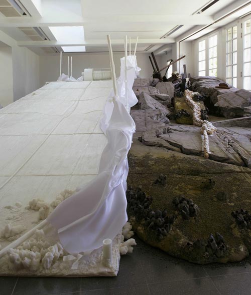 Matthew Barney. <em>Holographic Entry Point,</em> 2005. Self-lubricating plastic, polycaprolactone thermoplastic, shrimp shells, sea shells, cement, wood, steel, stainless steel, expanded polystyrene, vivac, pigment, acrylic paint, acrylic medium, sand, aquaplast, PVC. Installation at the Serpentine Gallery, London. Photograph © Hugo Glendinning