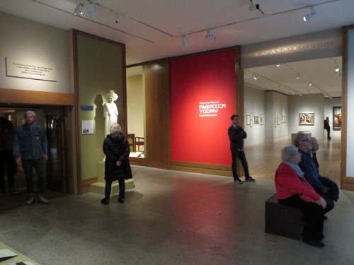 Anteroom for both the Frank Lloyd Wright period room (left) and the special Benton exhibition, with visitors watching museum video projected on wall introducing America Today (right).