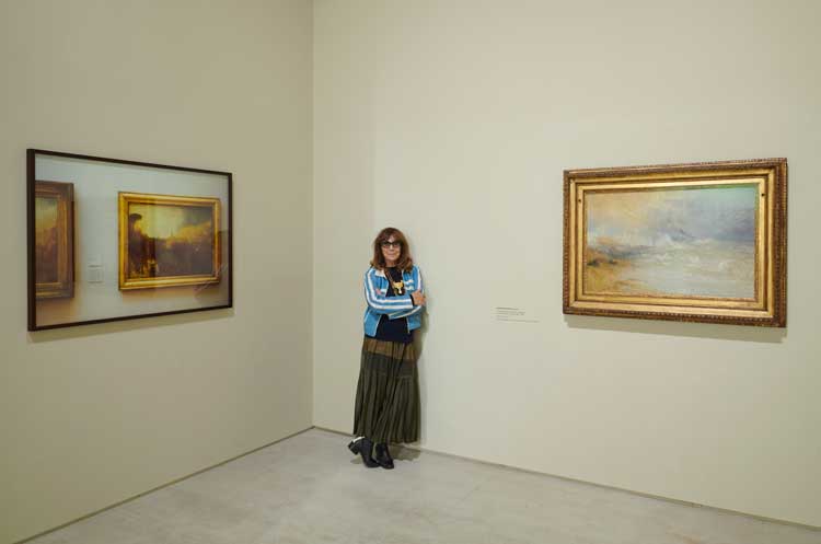Sophie Calle in front of Turners, 1998–2013 and JMW Turner, Waves Breaking on a Lee Shore at Margate (Study for ‘Rockets and Blue Lights’), c1840. Installation view of Sophie Calle: Something Missing?, 2026. Courtesy Turner Contemporary. Photo: Jo Underhill © Turner Contemporary.