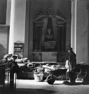 Cecil Beaton. Blitz: A workman with a wheelbarrow clears up fallen debris from the roof of St Mary-le-Bow after its first bombing, London, 1942. Part of Imperial War Museum’s ‘Ministry of Information Second World War Official Collection’.