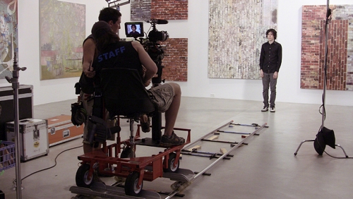 Xavier Cha. de la Cruz Shoot, 2011. Lights, dolly, track, DP, grip,actors. Film shoot as installation open to public view at the de la Cruz Collection.  Lighting and tracks were set up to capture two familiar cinematic shots.