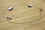 Paul Chan. Sock N Tease, 2013. Concrete, cord, shoes, and video projectors, with digital colour video, silent, 10.2 x 358.1 x 229.9 cm overall. Courtesy the artist and Greene Naftali, New York. © Paul Chan. Photograph: Tom Bisig, Basel.