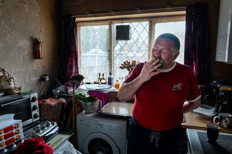 Malcolm at home, Brierley Hill, June 2017. "He has had a difficult life and struggles with mental health issues, but he’s trying to make the best of it. He finds it increasingly hard to be around people and that’s tricky while trying to hold down a job." – Merlin Daleman.