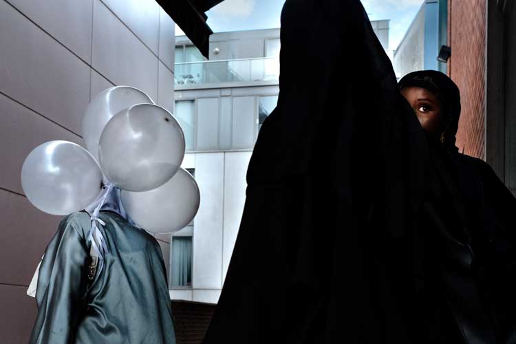 Mailbox, Birmingham, July 2024. "I spotted the young ladies walking into a coffee shop, hoping to catch them on their way out, when the girl on the left looked over in my direction." – Merlin Daleman.