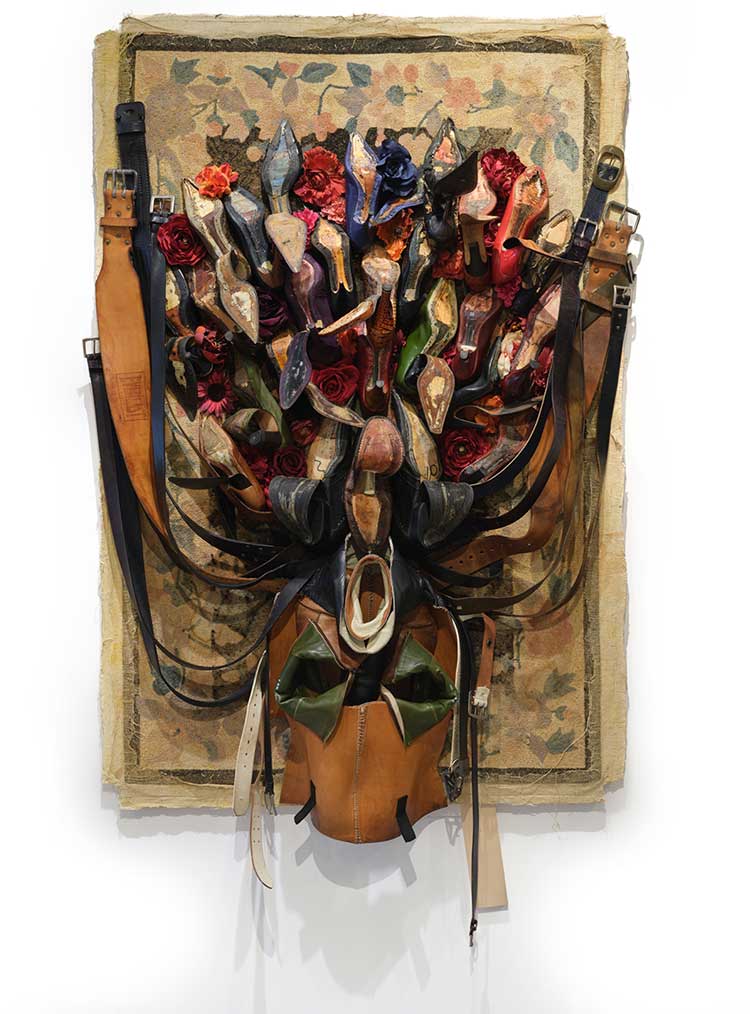 Anindita Dutta, Song Under the Carpet, 2025, carpet, used shoes, belts, artificial flowers, 80 × 49 × 12 in.